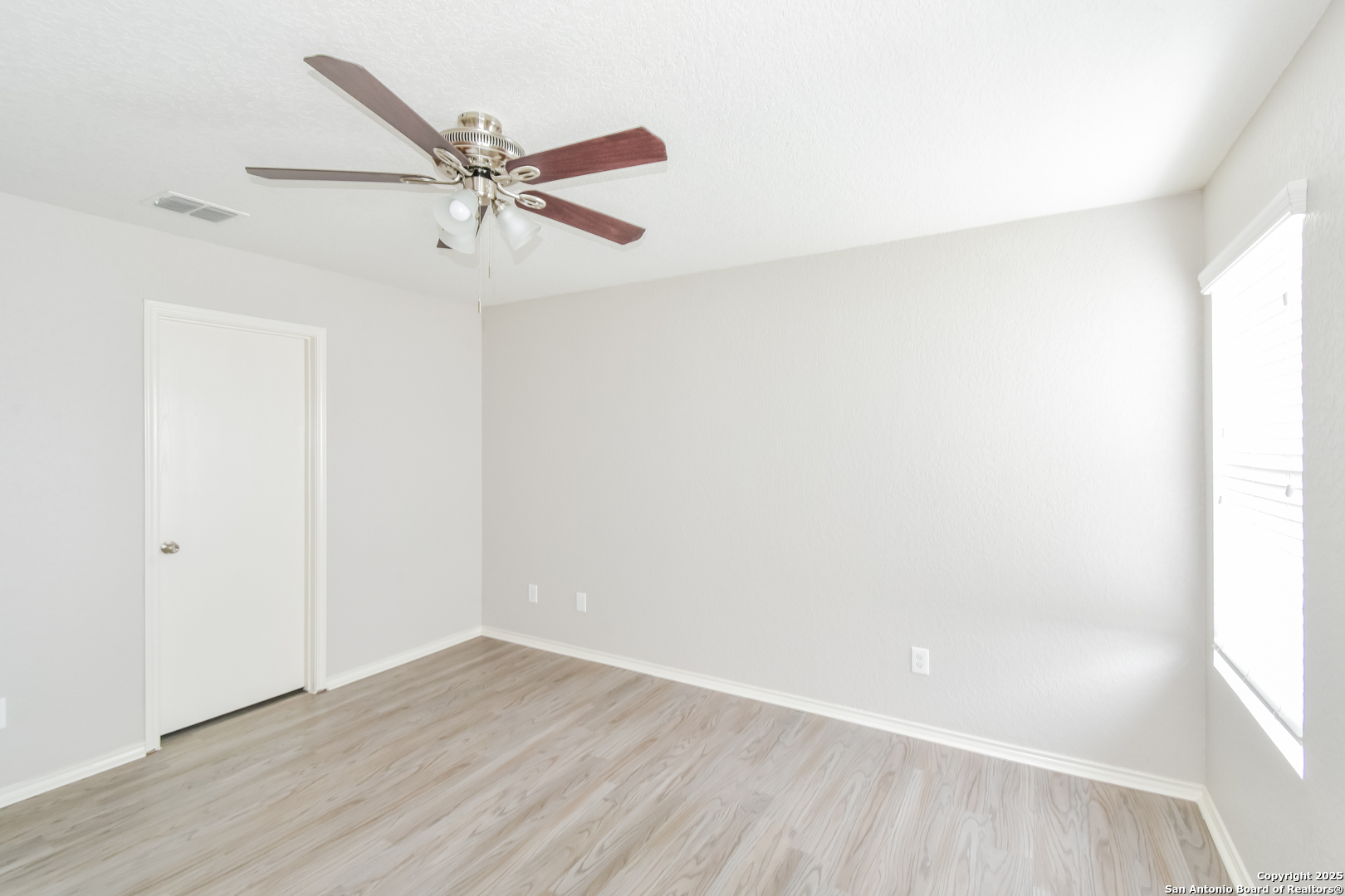 3603 Alonzo Fields Converse, TX 78109 - Photo 10 of 16 a view of a room with wooden floor and ceiling fan