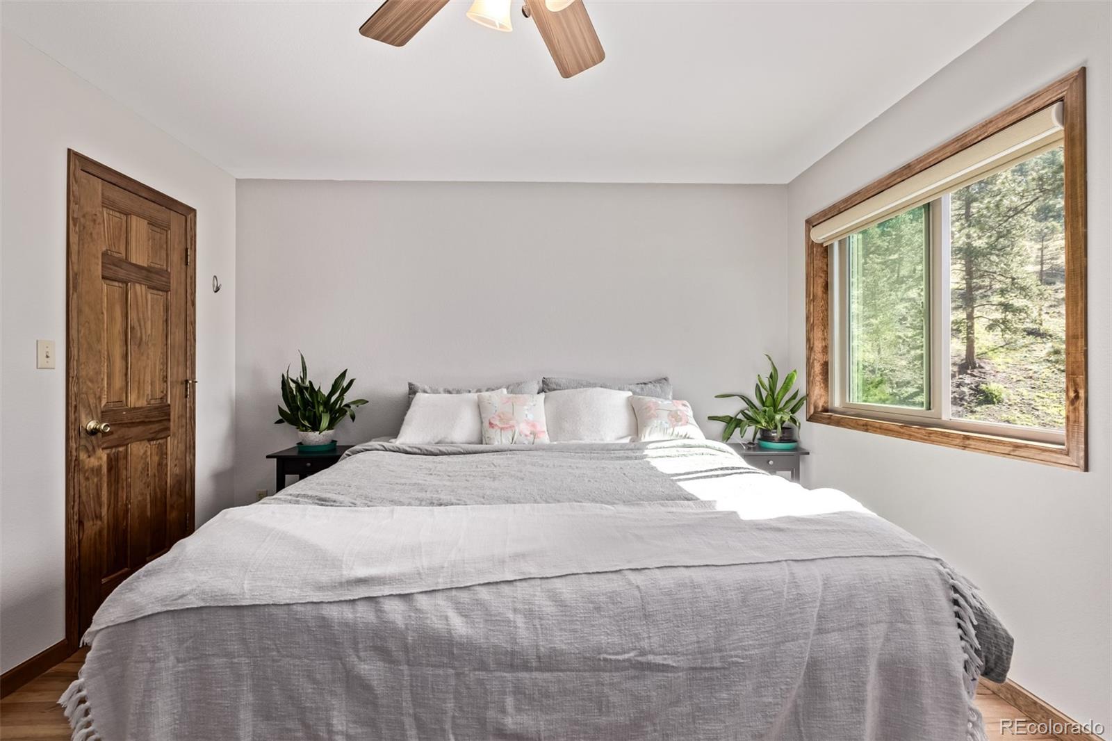 13950 Pine Valley Road Pine, CO 80470 - Photo 15 of 49 a large bed sitting in a bedroom next to a window