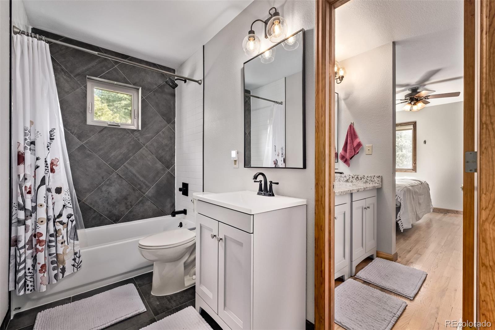 13950 Pine Valley Road Pine, CO 80470 - Photo 18 of 49 a bathroom with a sink toilet and shower