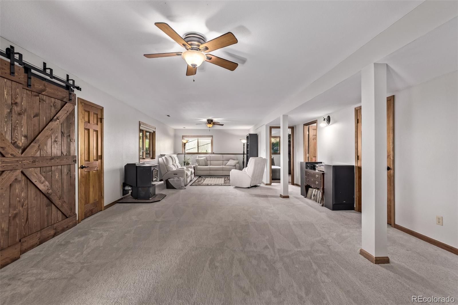 13950 Pine Valley Road Pine, CO 80470 - Photo 23 of 49 a living room with furniture and a chandelier