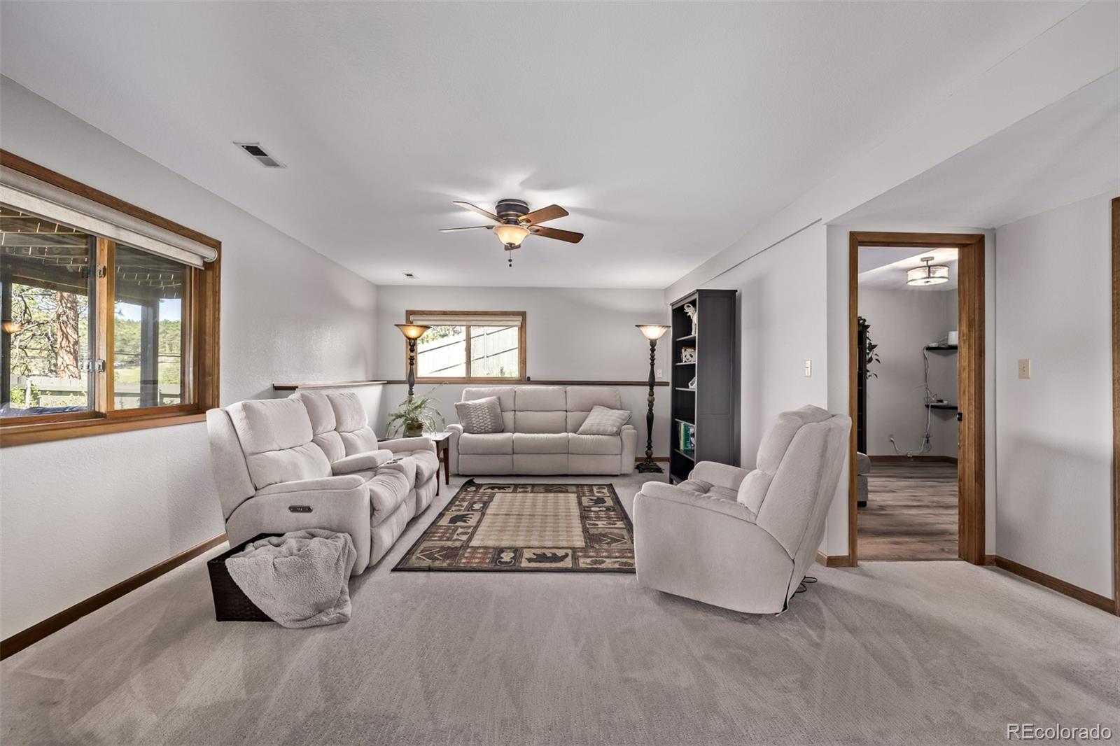 13950 Pine Valley Road Pine, CO 80470 - Photo 24 of 49 a living room with furniture and a chandelier