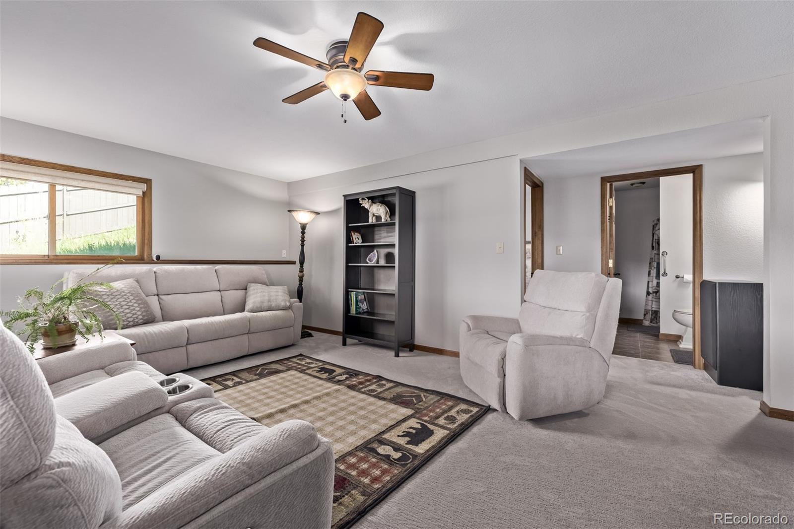 13950 Pine Valley Road Pine, CO 80470 - Photo 25 of 49 a living room with furniture and a rug