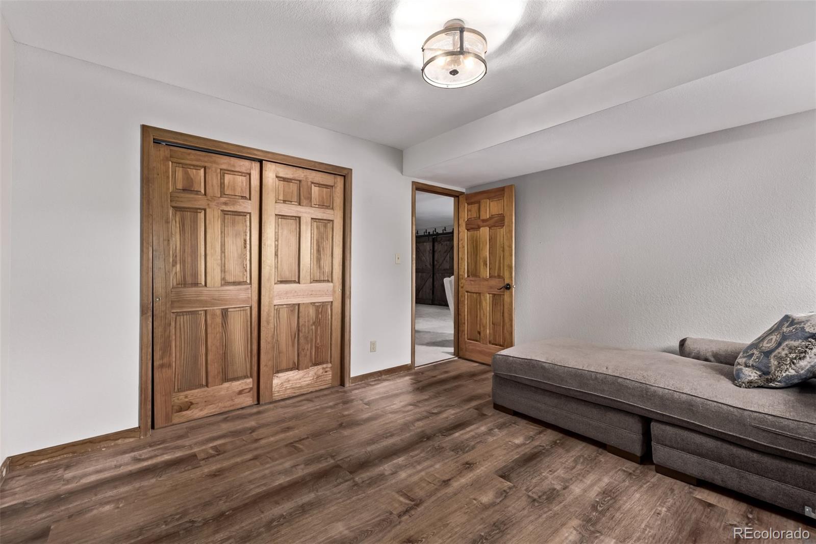 13950 Pine Valley Road Pine, CO 80470 - Photo 30 of 49 an empty room with wooden floor and windows