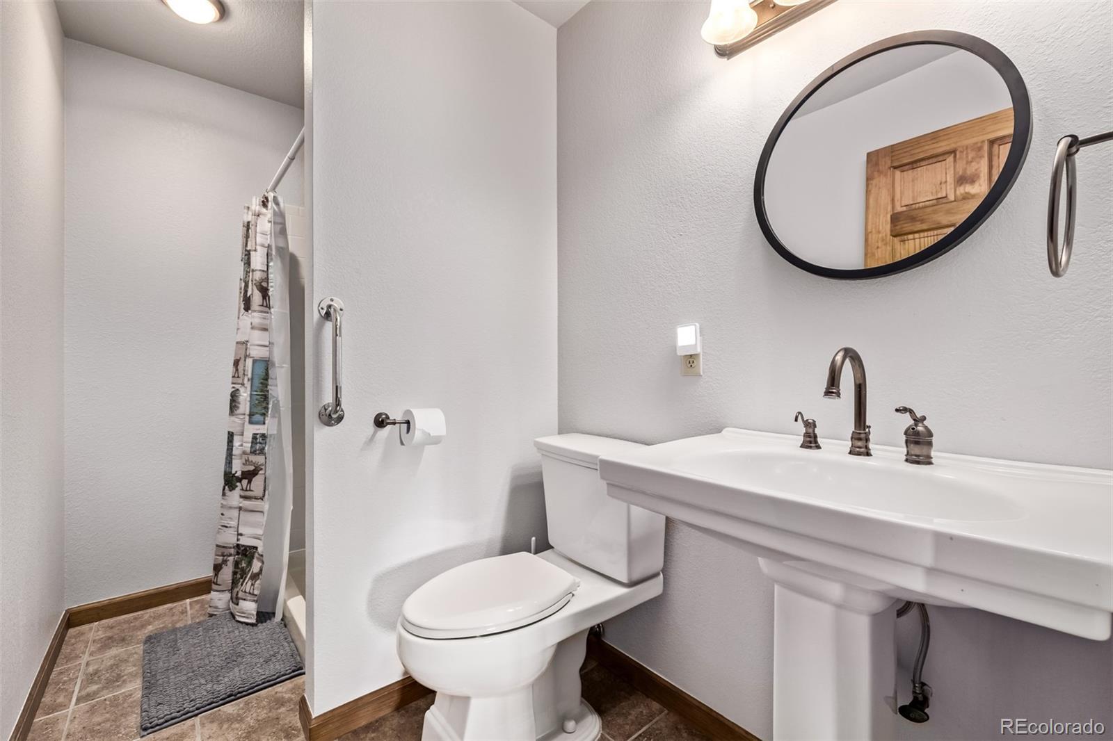 13950 Pine Valley Road Pine, CO 80470 - Photo 31 of 49 a bathroom with a sink and a mirror