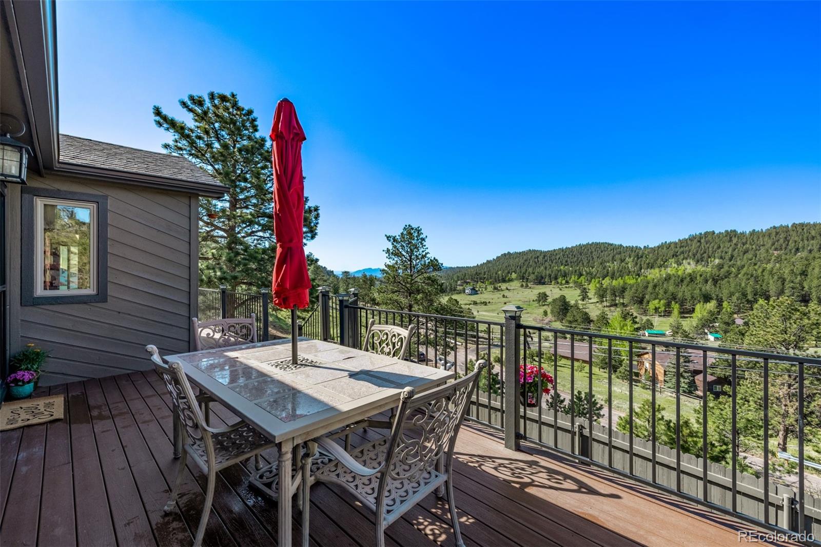 13950 Pine Valley Road Pine, CO 80470 - Photo 38 of 49 a view of a balcony with furniture and a potted plant