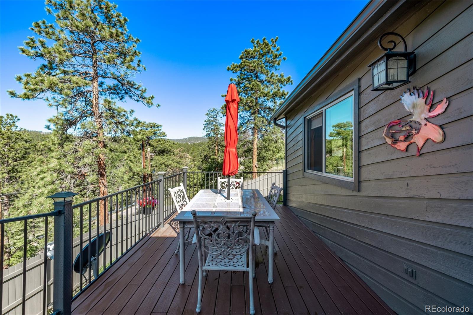 13950 Pine Valley Road Pine, CO 80470 - Photo 39 of 49 a balcony with wooden floor table and chairs