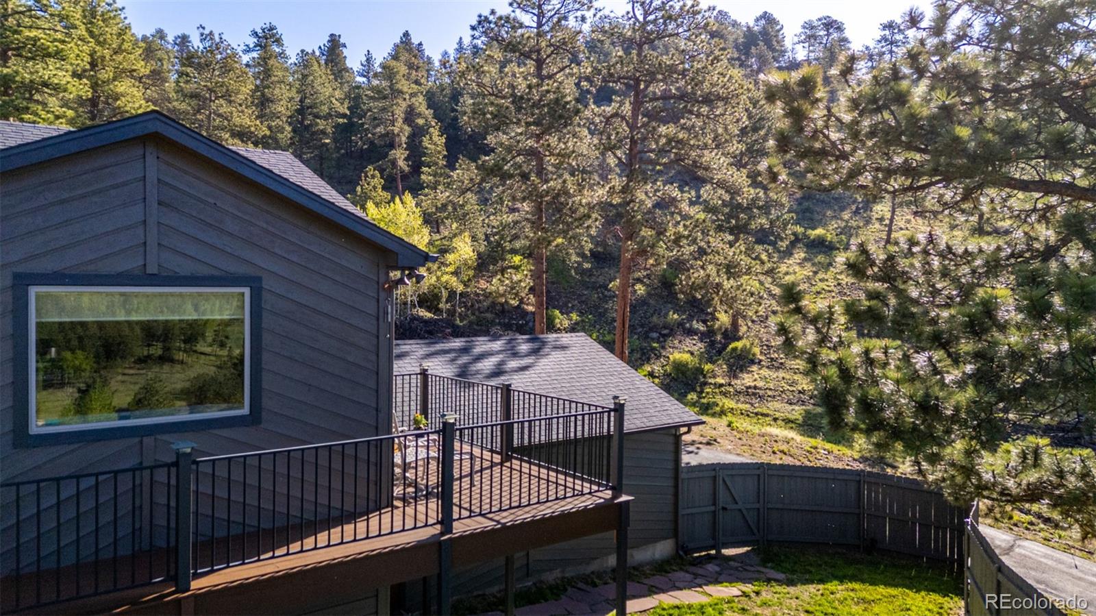 13950 Pine Valley Road Pine, CO 80470 - Photo 40 of 49 a view of a wooden fence and a floor to ceiling window