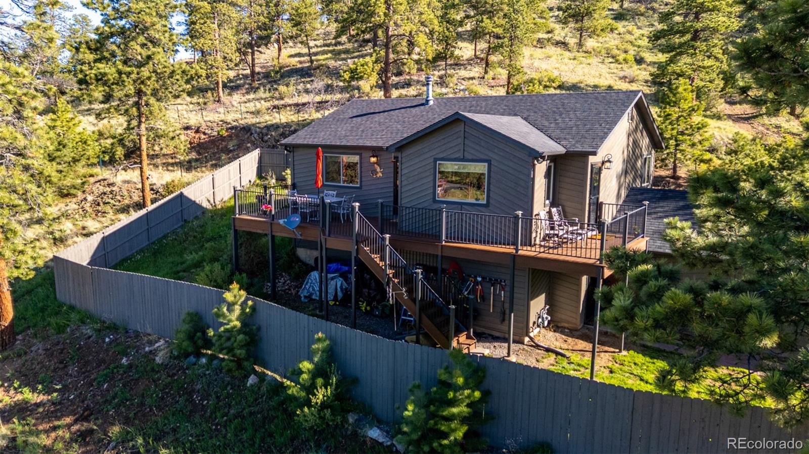 13950 Pine Valley Road Pine, CO 80470 - Photo 41 of 49 a view of a house with brick walls and flower plants