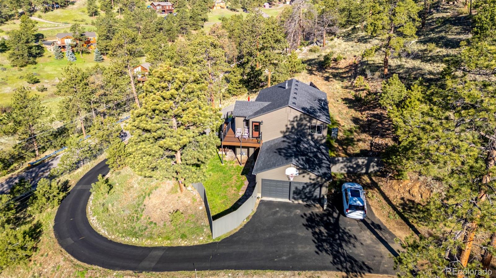 13950 Pine Valley Road Pine, CO 80470 - Photo 42 of 49 an aerial view of a house with a swimming pool