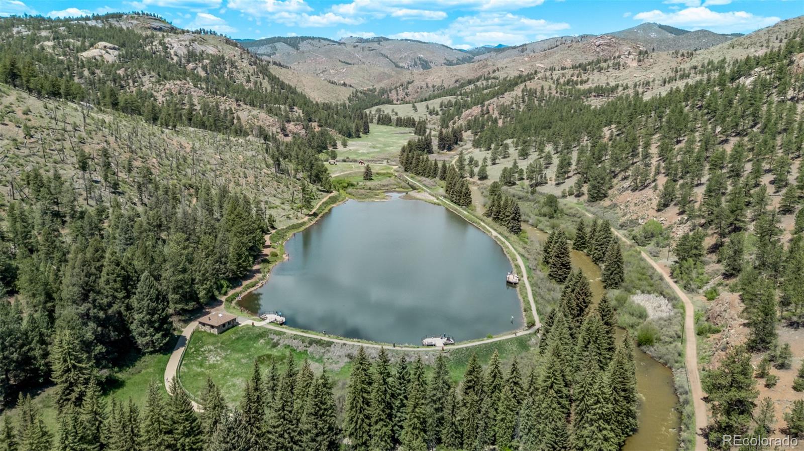 13950 Pine Valley Road Pine, CO 80470 - Photo 45 of 49 an aerial view of a house with a yard and large trees