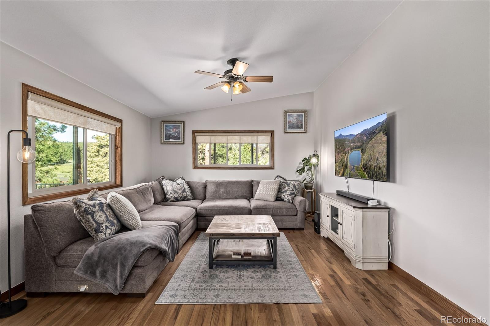 13950 Pine Valley Road Pine, CO 80470 - Photo 5 of 49 a living room with furniture a window and a flat screen tv