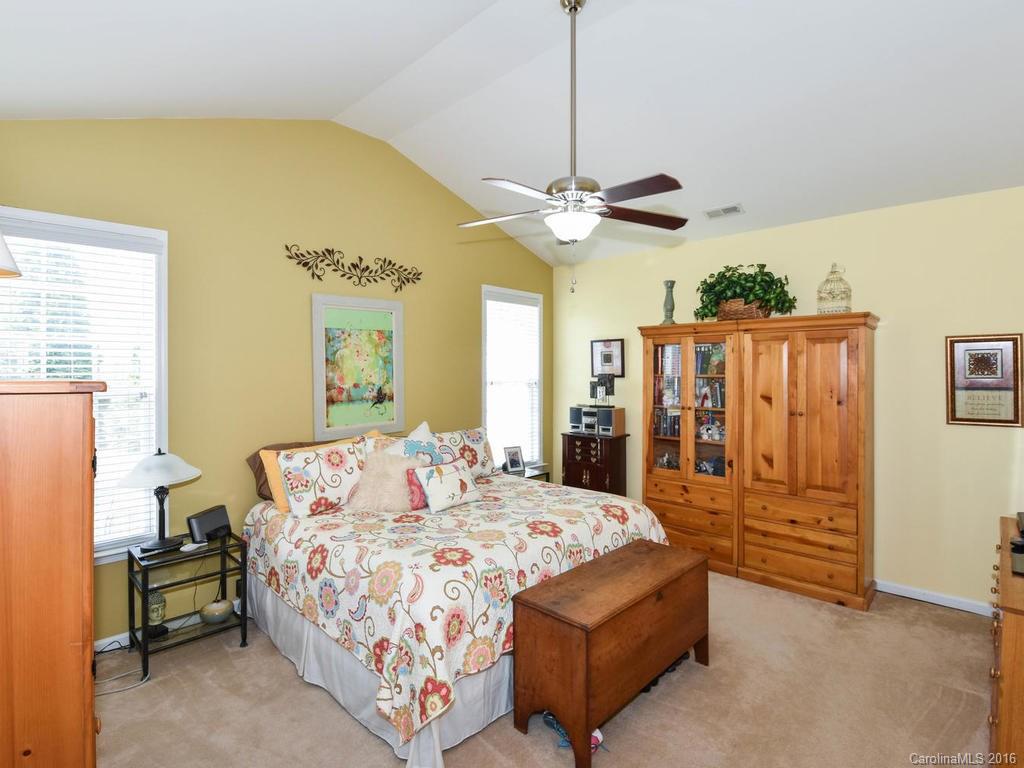207 Garnet Court, Unit 561 Fort Mill, SC 29708 - Photo 11 of 21 a spacious bedroom with a bed chandelier and a window