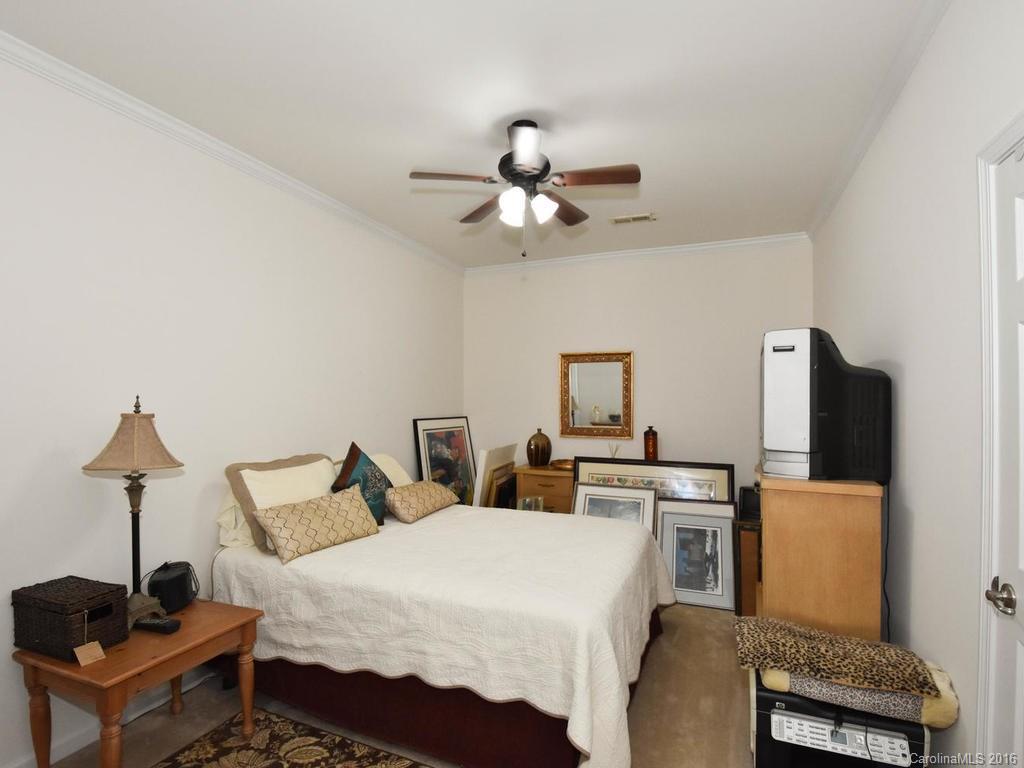 207 Garnet Court, Unit 561 Fort Mill, SC 29708 - Photo 14 of 21 a bedroom with furniture a bed and a flat screen tv