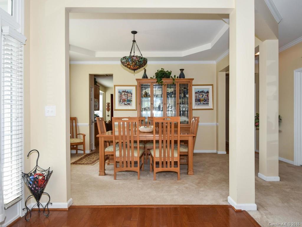 207 Garnet Court, Unit 561 Fort Mill, SC 29708 - Photo 6 of 21 a view of a dining room and livingroom with furniture wooden floor a chandelier