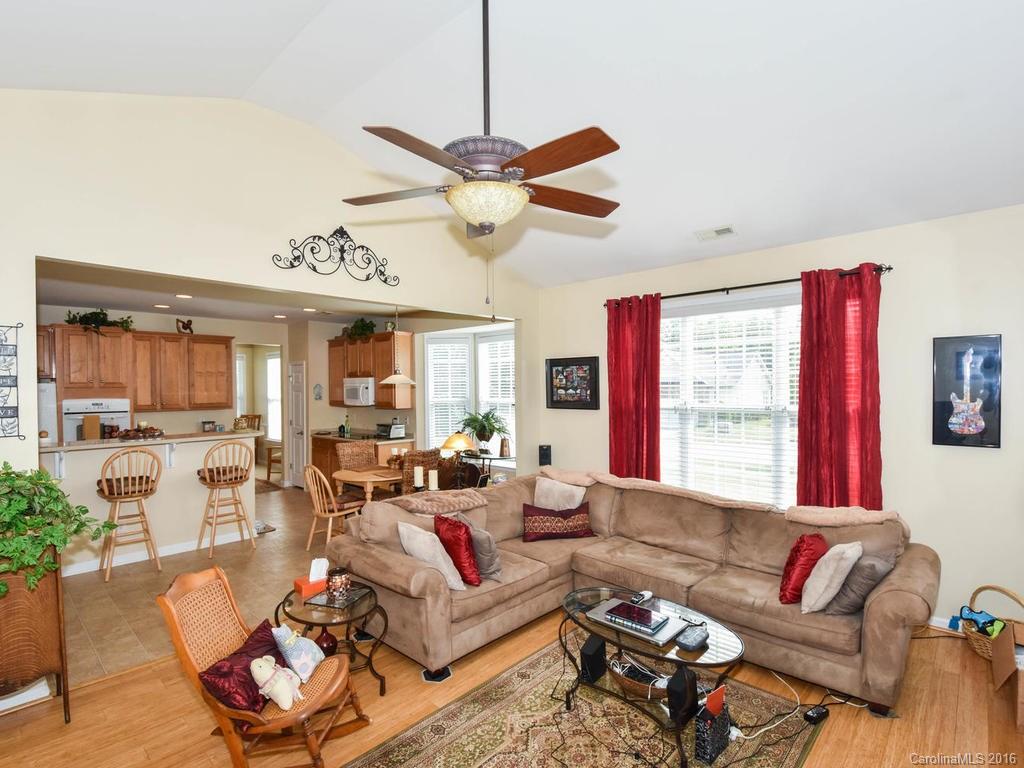 207 Garnet Court, Unit 561 Fort Mill, SC 29708 - Photo 8 of 21 a living room with furniture a large window and a chandelier
