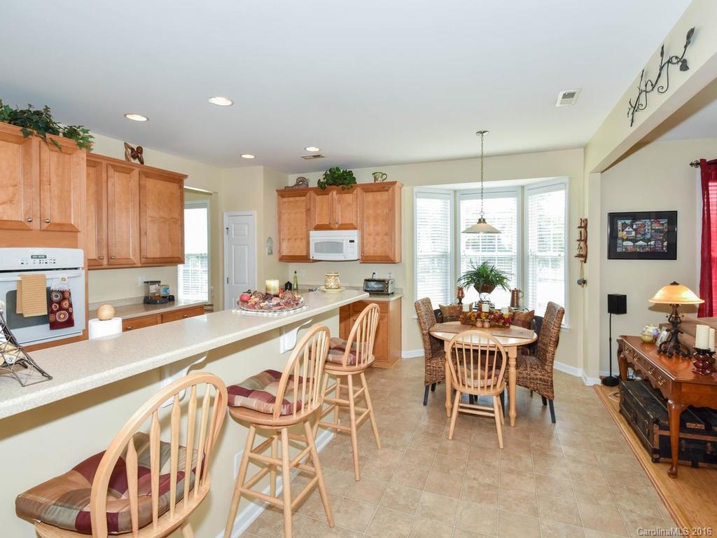 207 Garnet Court, Unit 561 Fort Mill, SC 29708 - Photo 9 of 21 a large kitchen with a table and chairs