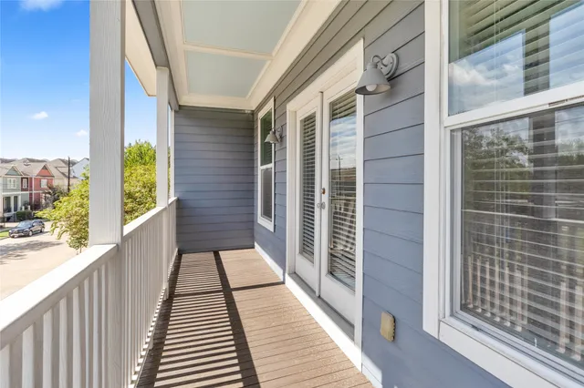 a view of a balcony with wooden floor