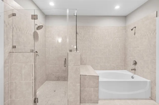 a bathroom with a bathtub and shower
