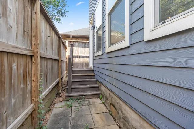 a view of staircase with wooden floor and a window