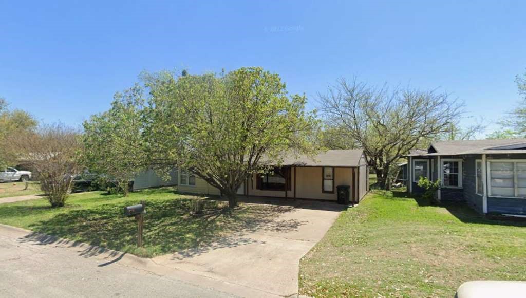 905 Euclid Street Cleburne, TX 76033 - Photo 1 of 15 a front view of a house with a yard and garage