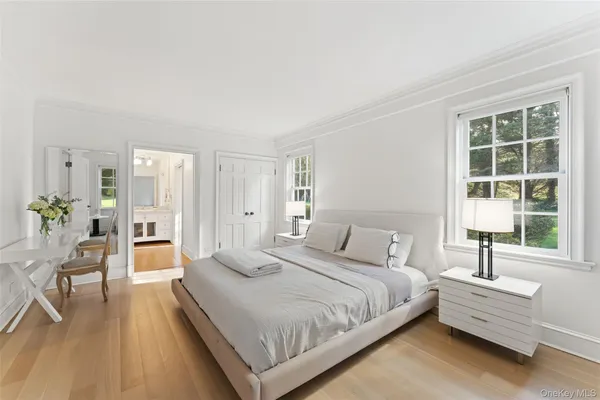 a spacious bedroom with a bed and a large window