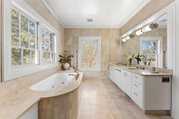 a large white kitchen with a large window