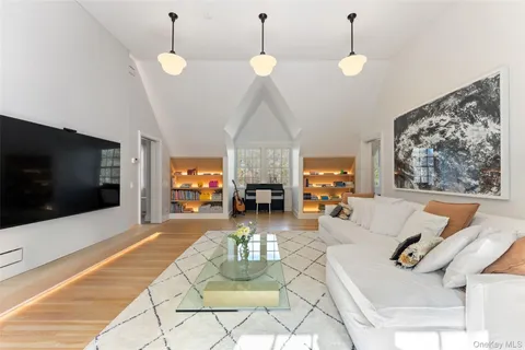 a living room with fireplace furniture and a flat screen tv
