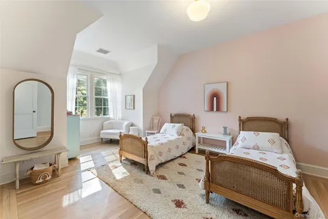 a bed room with two beds and a large window