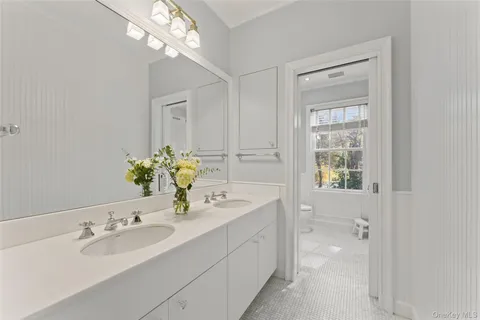 a bathroom with a sink a vanity and a mirror