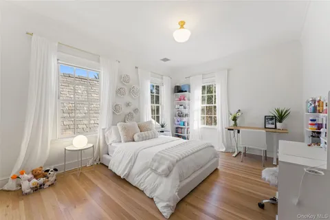 a bedroom with a bed and a large window