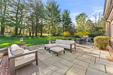a view of a yard with furniture and garden