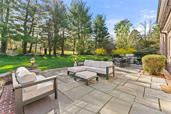 a view of a yard with furniture and garden