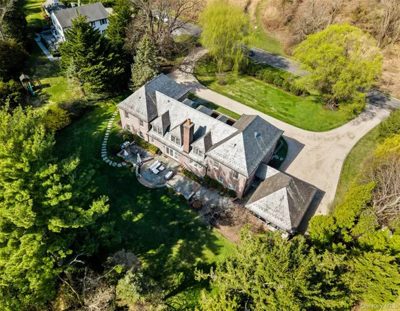an aerial view of a house with garden space and street view