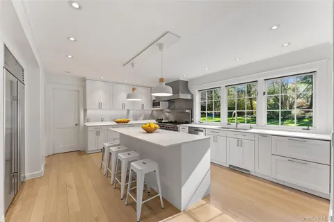 a view of kitchen with wooden floor and electronic appliances