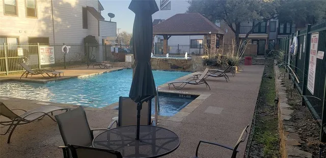 a view of a swimming pool with sitting area