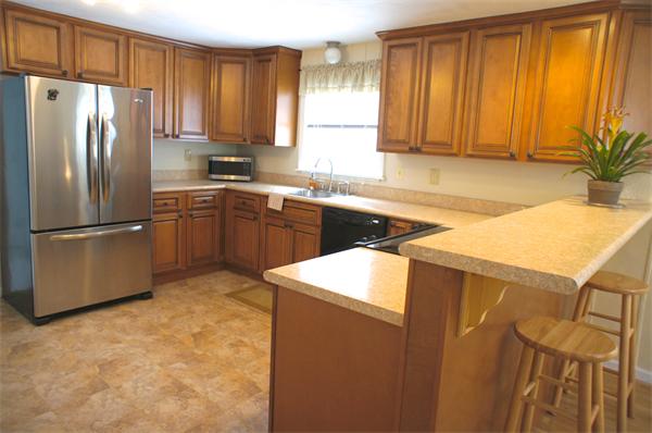 118 Washington Road Brimfield, MA 01010 - Photo 6 of 20 a kitchen with stainless steel appliances granite countertop a refrigerator a sink a stove with wooden cabinets