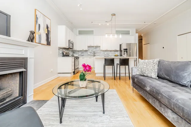 a living room with furniture and kitchen view