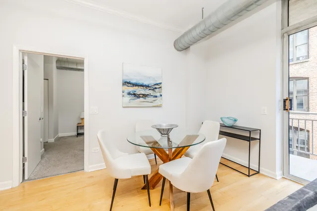 a view of a dining room with furniture and a window