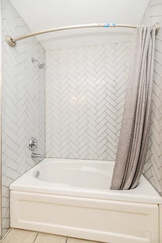 a bathroom with a bathtub and a shower
