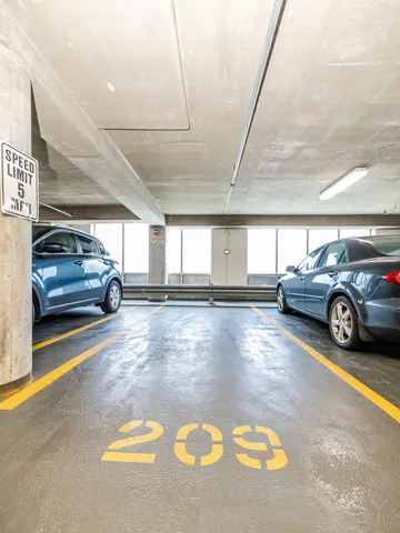 a view of parking garage with cars parked