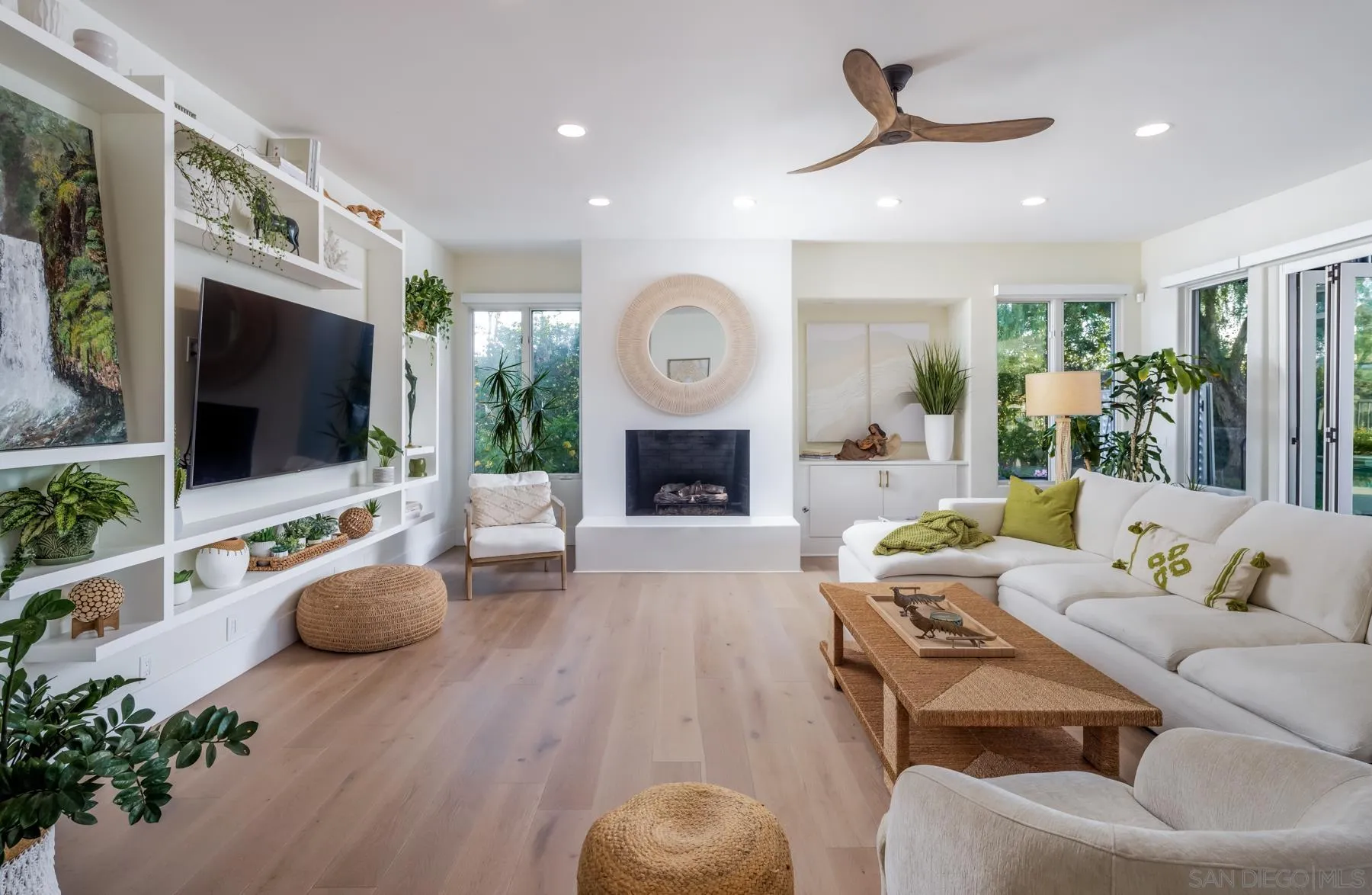 7430 St Andrews Road Rancho Santa Fe, CA 92067 - Photo 12 of 48 a living room with furniture a flat screen tv and a fireplace