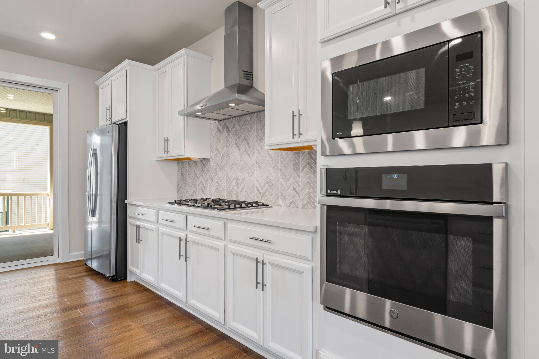 7504 Overview Terrace Columbia, MD 21044 - Photo 11 of 54 a kitchen with stainless steel appliances white cabinets and a stove top oven