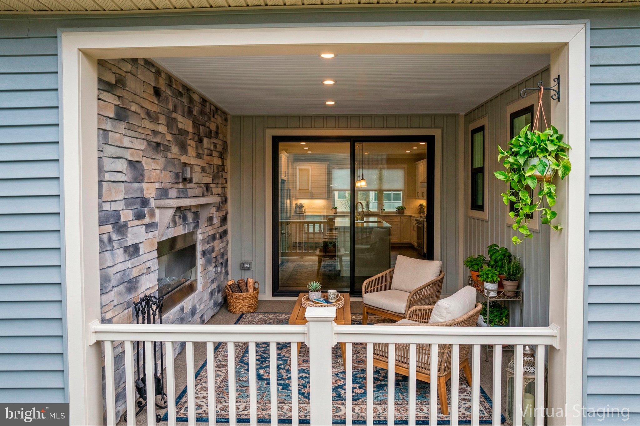 7504 Overview Terrace Columbia, MD 21044 - Photo 24 of 54 a view of a porch with a floor to ceiling window and potted plants