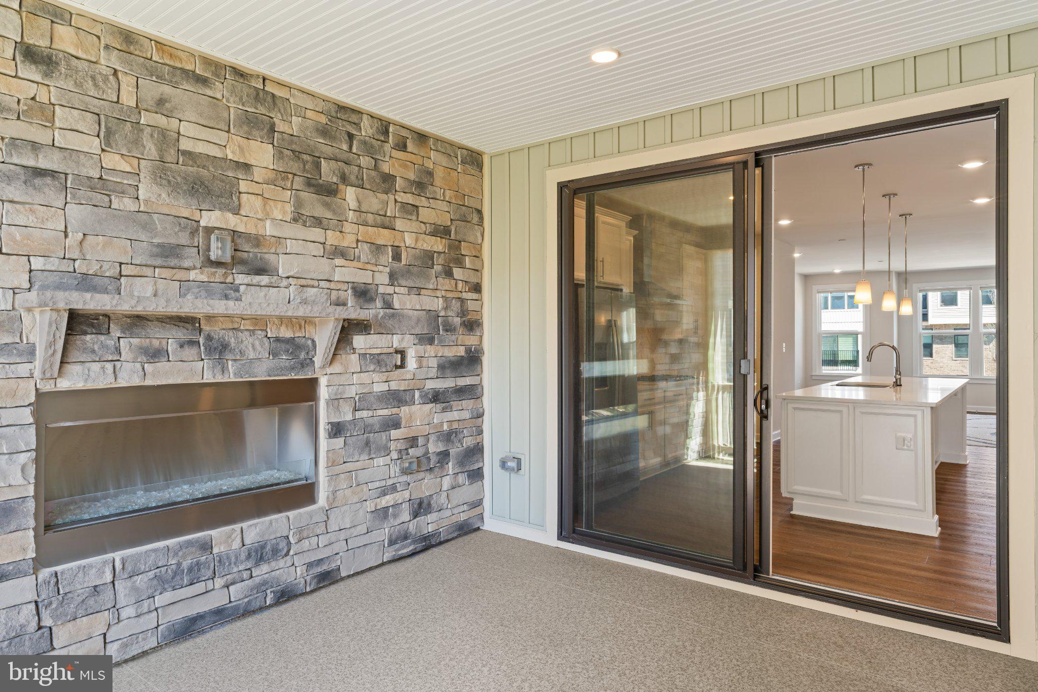 7504 Overview Terrace Columbia, MD 21044 - Photo 26 of 54 a living room with a fireplace and a glass door shower