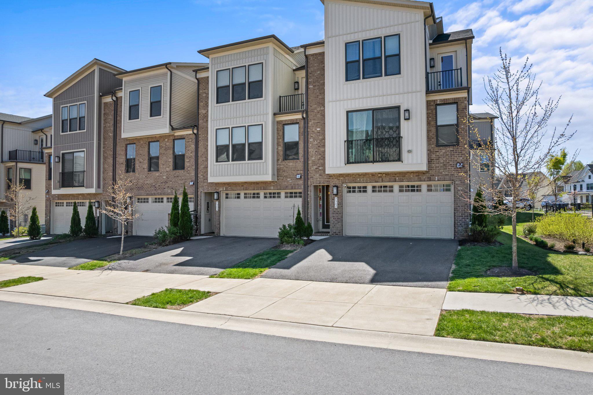 7504 Overview Terrace Columbia, MD 21044 - Photo 44 of 54 a front view of a building with garden and parking