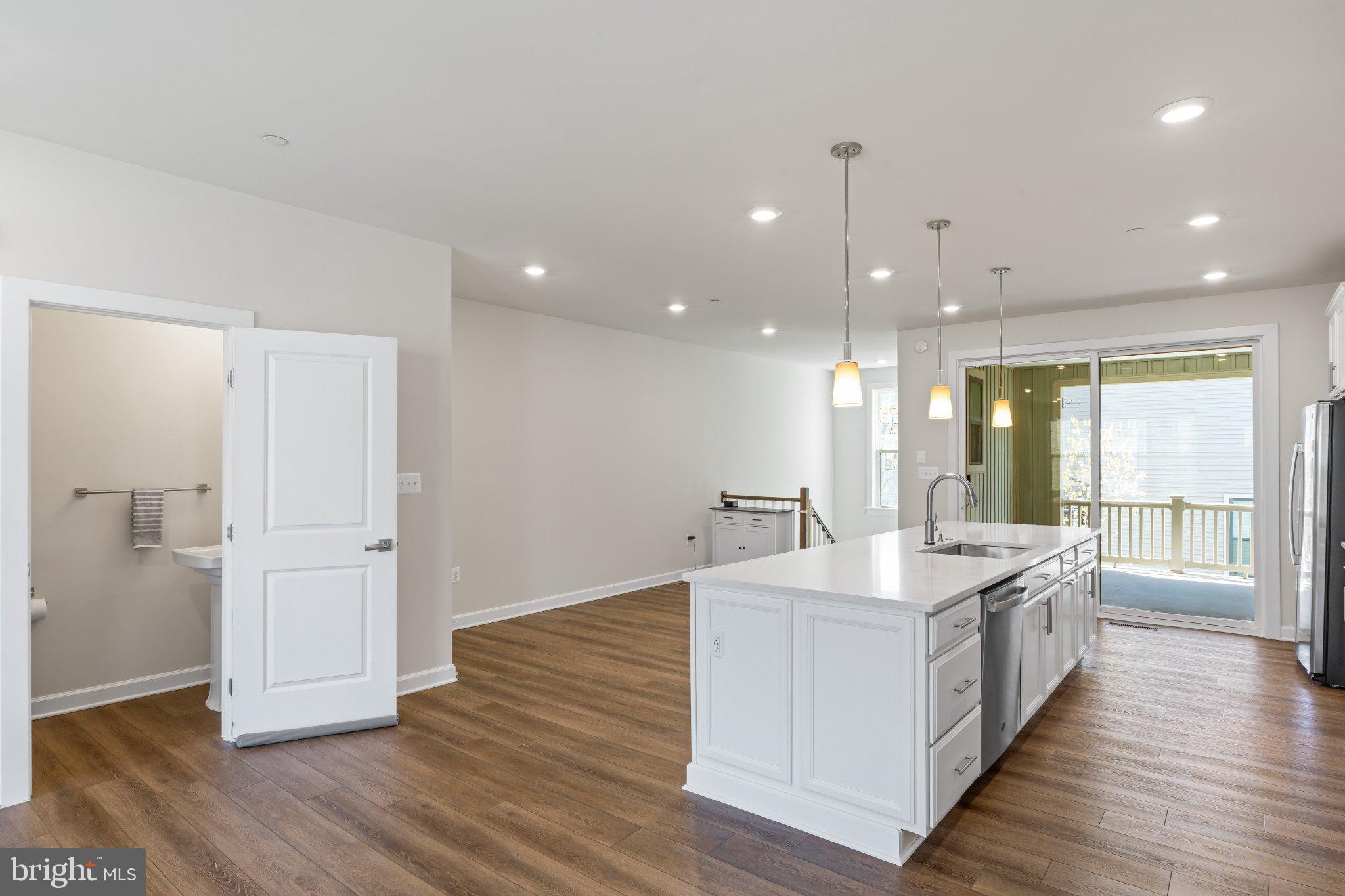 7504 Overview Terrace Columbia, MD 21044 - Photo 9 of 54 a large room with kitchen island a wooden floor
