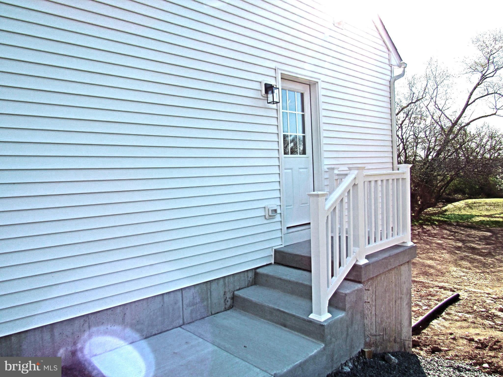 957 Spring City Road Phoenixville, PA 19460 - Photo 4 of 57 side entry to kit pantry, powder rm & coat closet