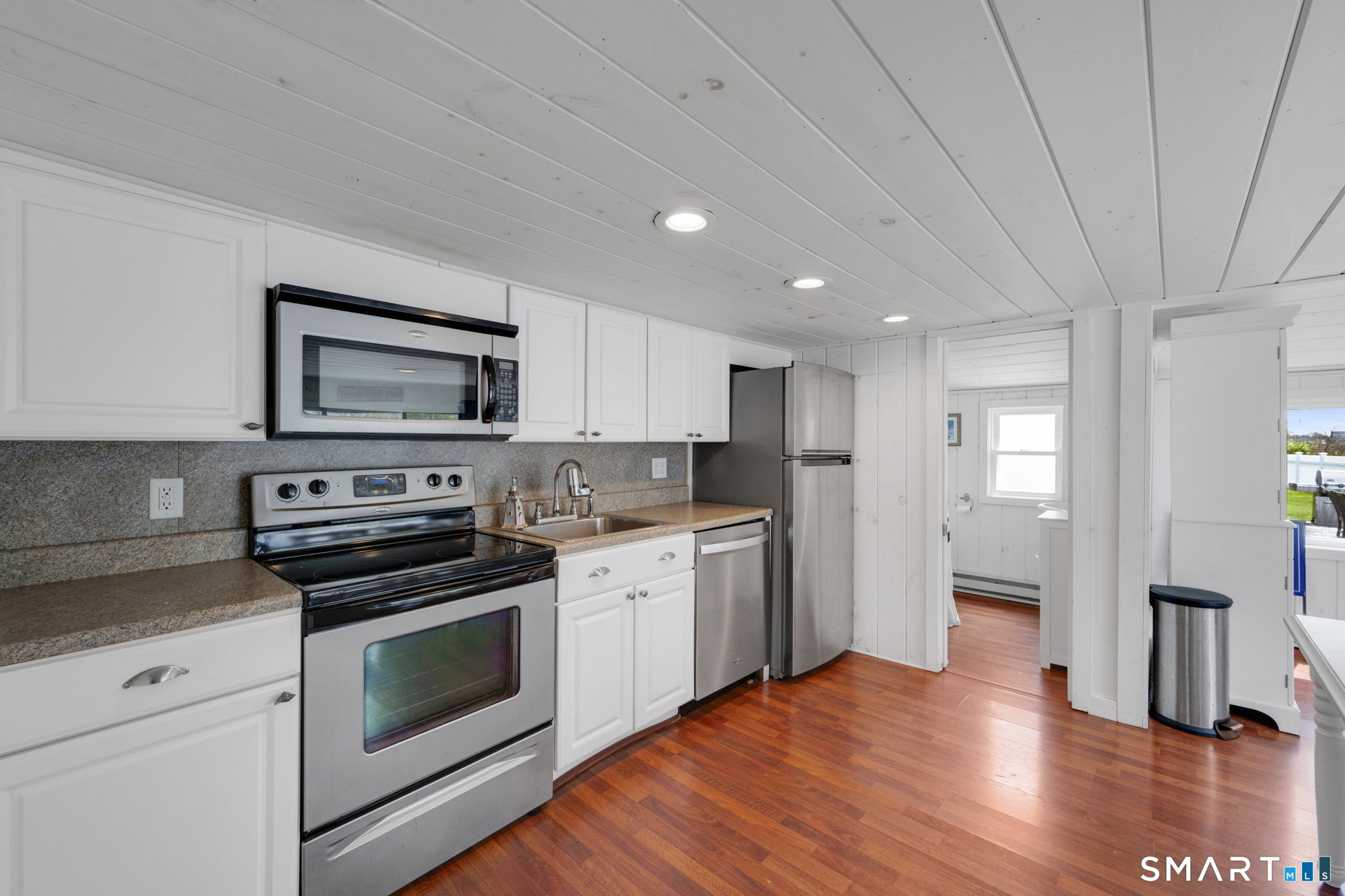 96 Chalker Beach Road Old Saybrook, CT 06475 - Photo 18 of 33 a kitchen with granite countertop a stove a sink and a refrigerator