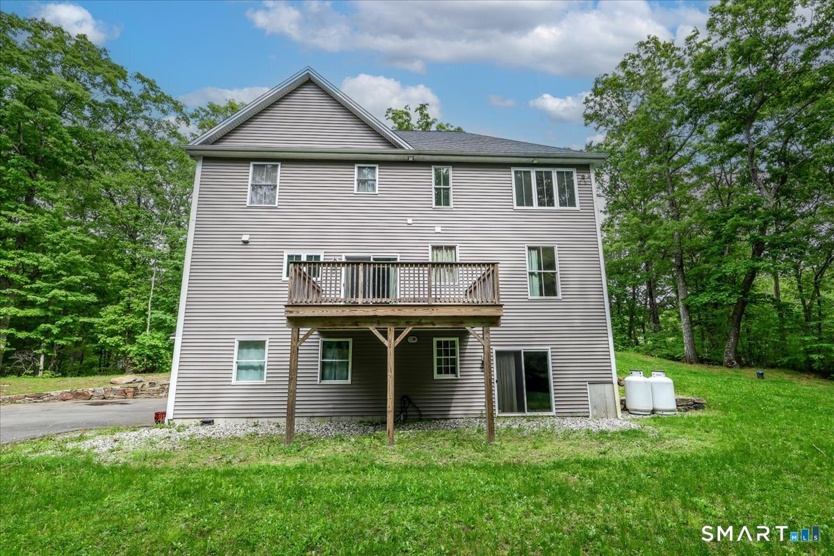 127 Putnam Park Road Bethel, CT 06801 - Photo 26 of 35 a front view of a house with a yard and garage