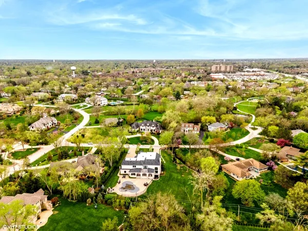 an aerial view of residential building with trees